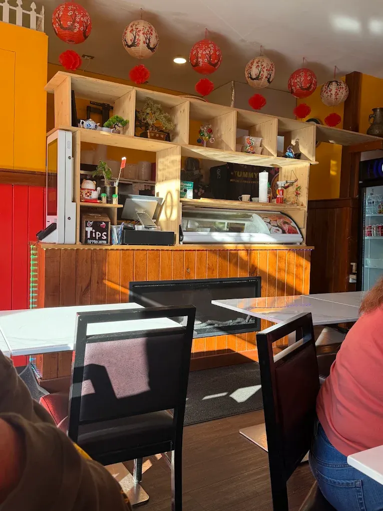 Inside Ichiban: mustard walls, red paneling, hanging lanterns and the order counter.