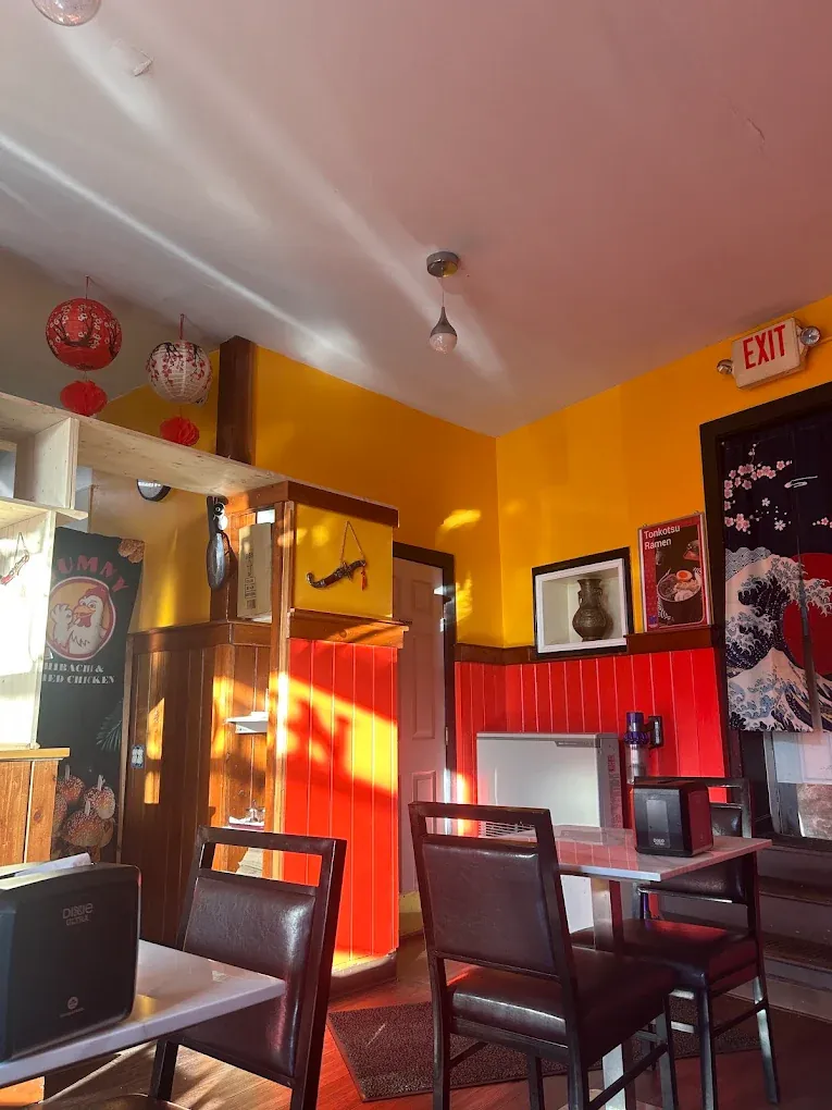 The dining room with black chairs and red lanterns.